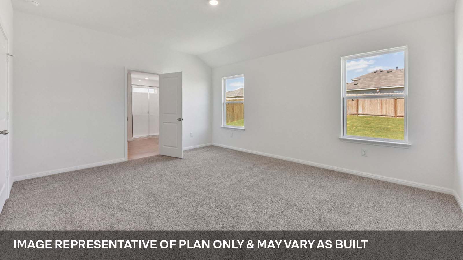 Primary bedroom with carpeted flooring and two windows.