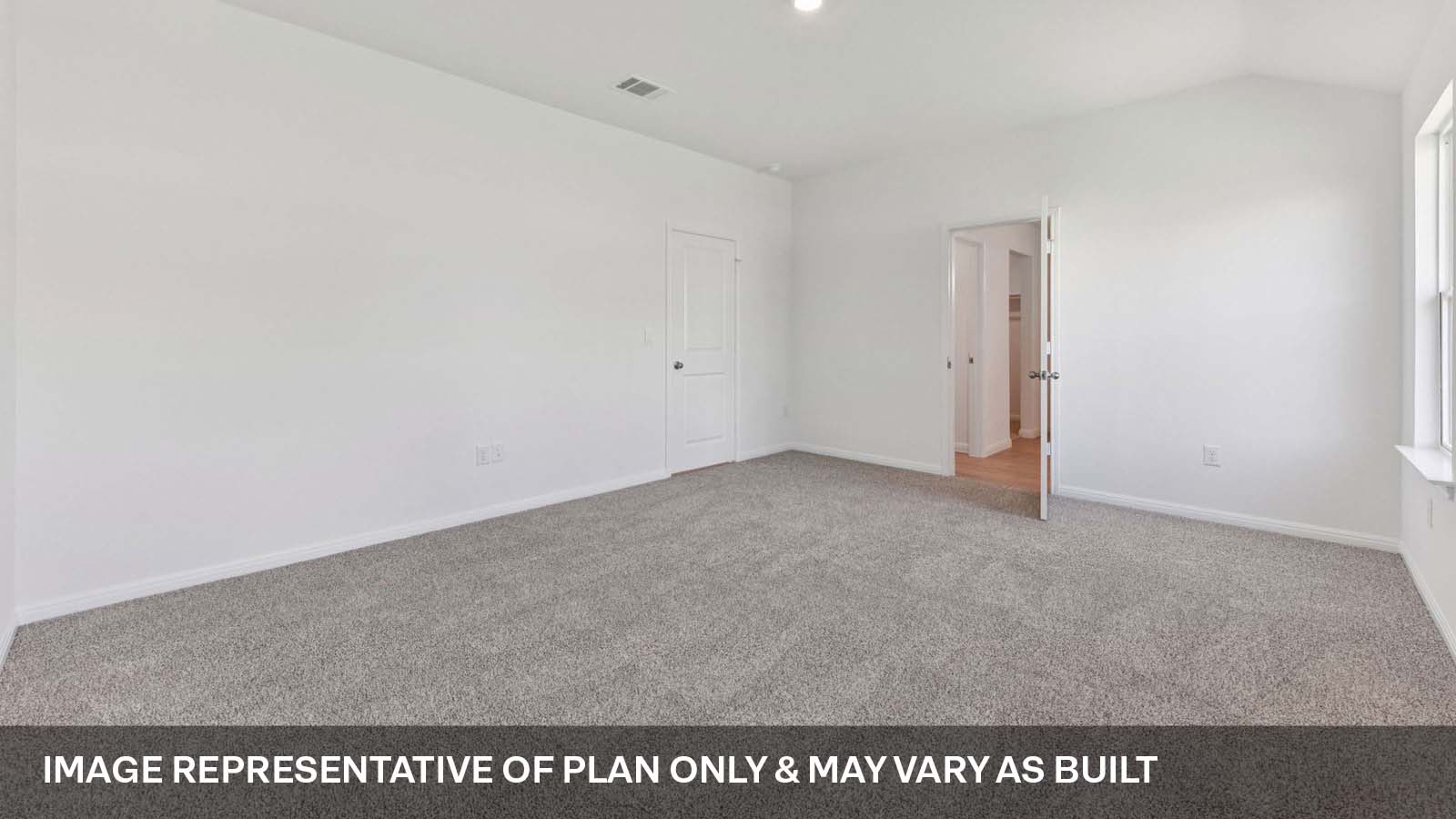Primary bedroom with carpeted flooring and two windows.