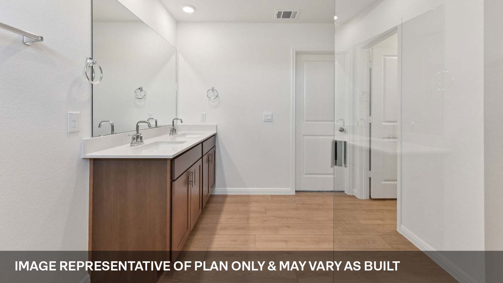 Luxurious primary bathroom with walk-in shower and quartz vanity.