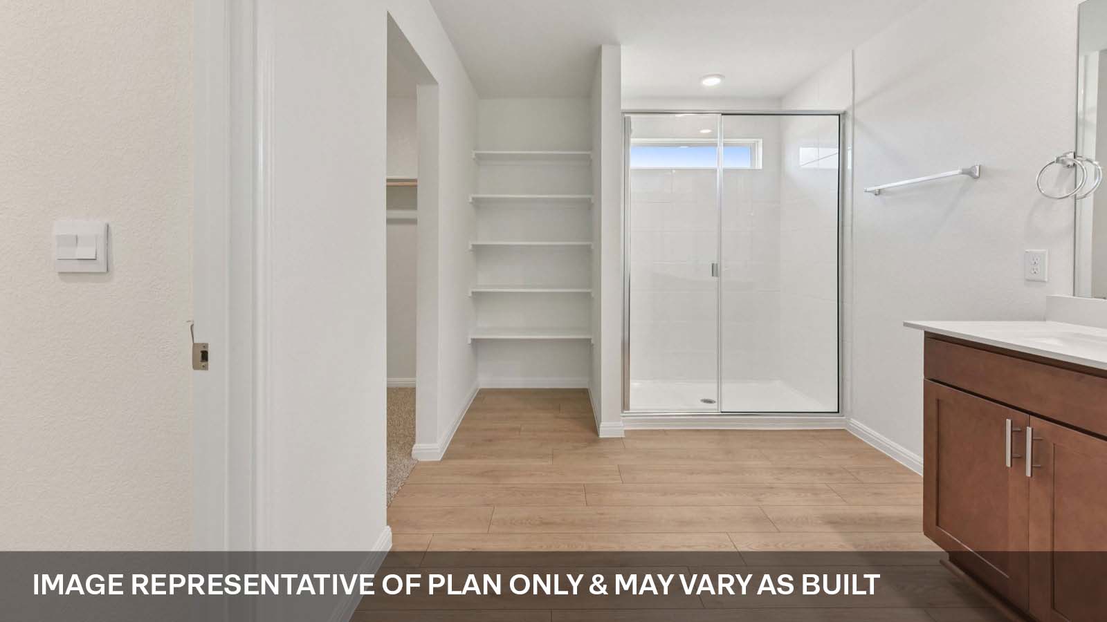 Luxurious primary bathroom with walk-in shower and quartz vanity.
