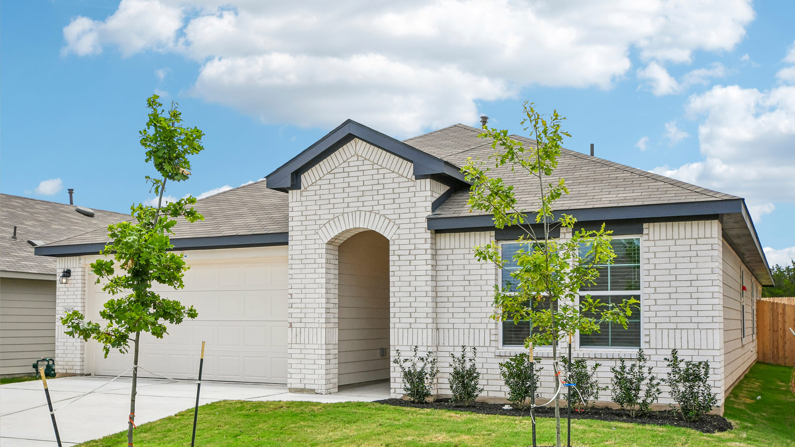 Exterior shot of 20405 Tuberville Lane at Carillon in Manor, TX - The Lakeway floorplan.