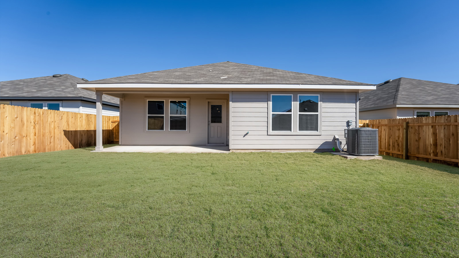 Back exterior of the Harris floorplan - B Elevation at Carillon in Manor, TX..