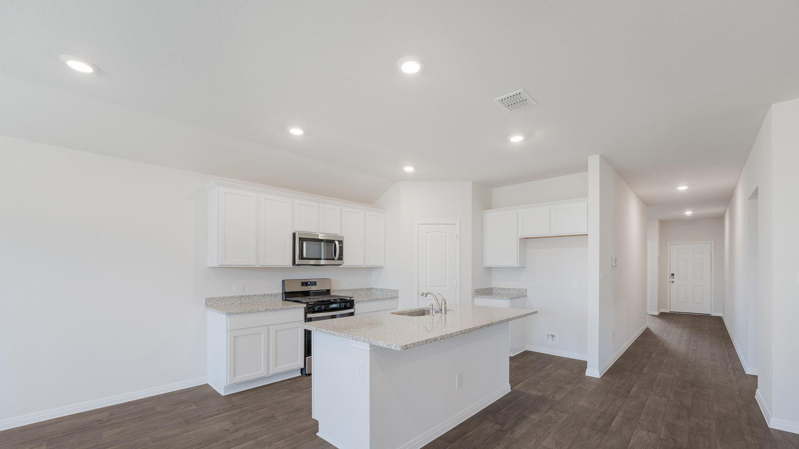 Modern kitchen with granite countertops and stainless steel appliances.