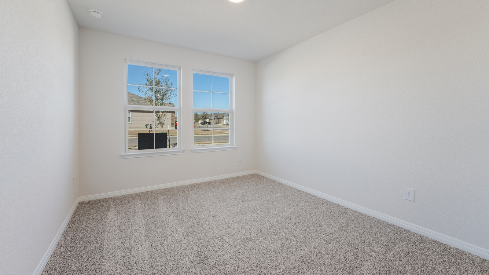 Bedroom 2 with carpeted flooring.