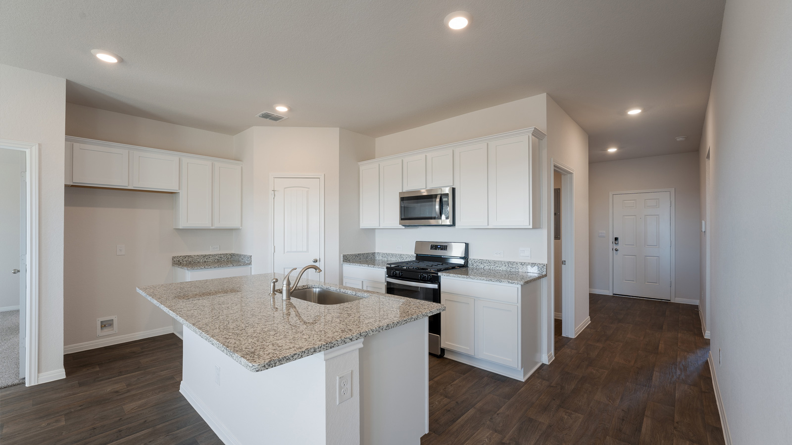 Kitchen with granite countertops and stainless steel appliances.