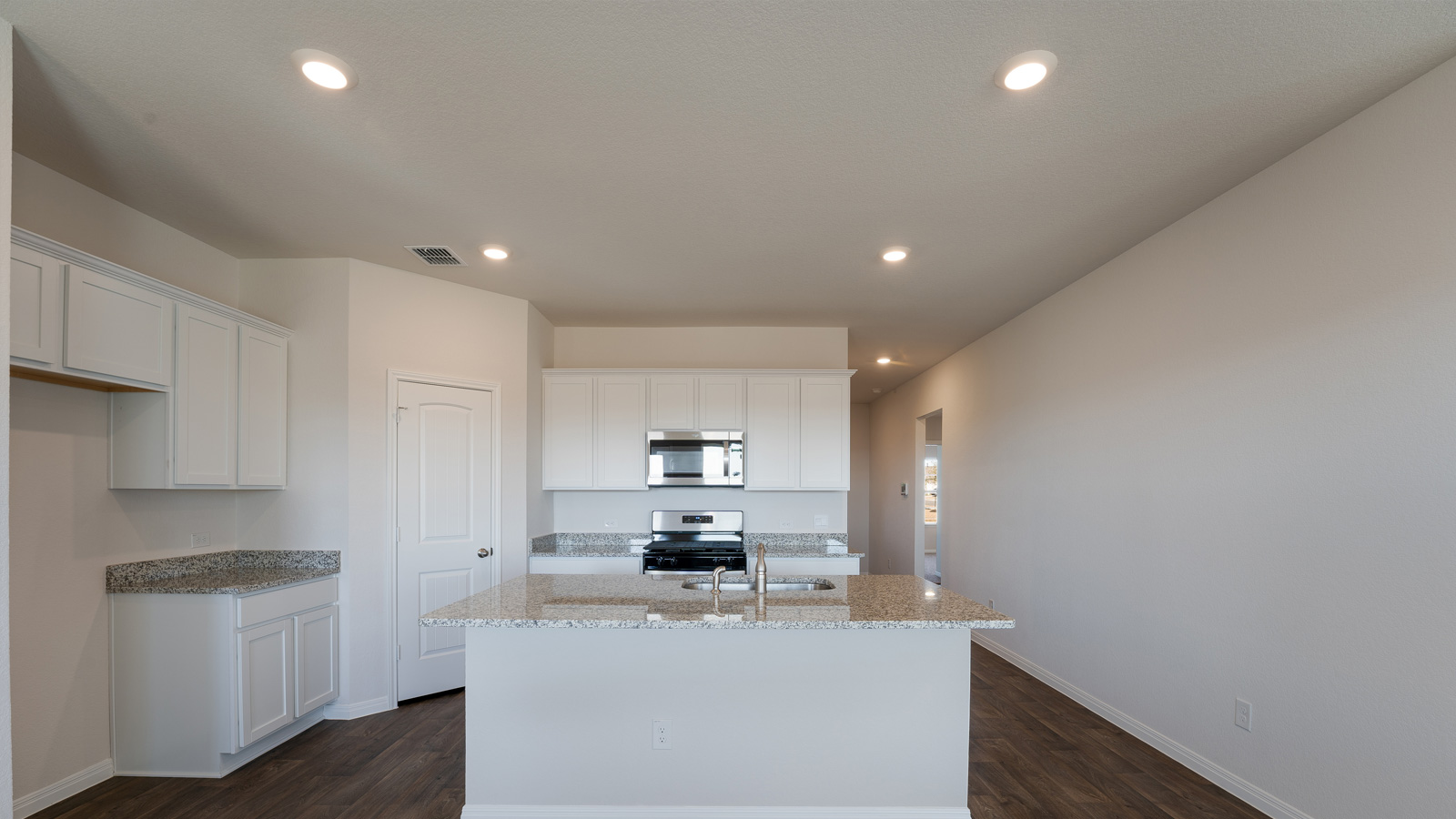 Kitchen with granite countertops and stainless steel appliances.