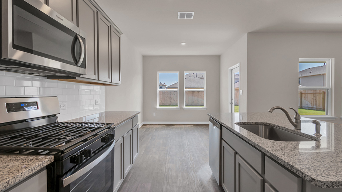New appliances and a larger kitchen island, a sink, seating anchor our kitchen, pantry, near dining, living and great rooms