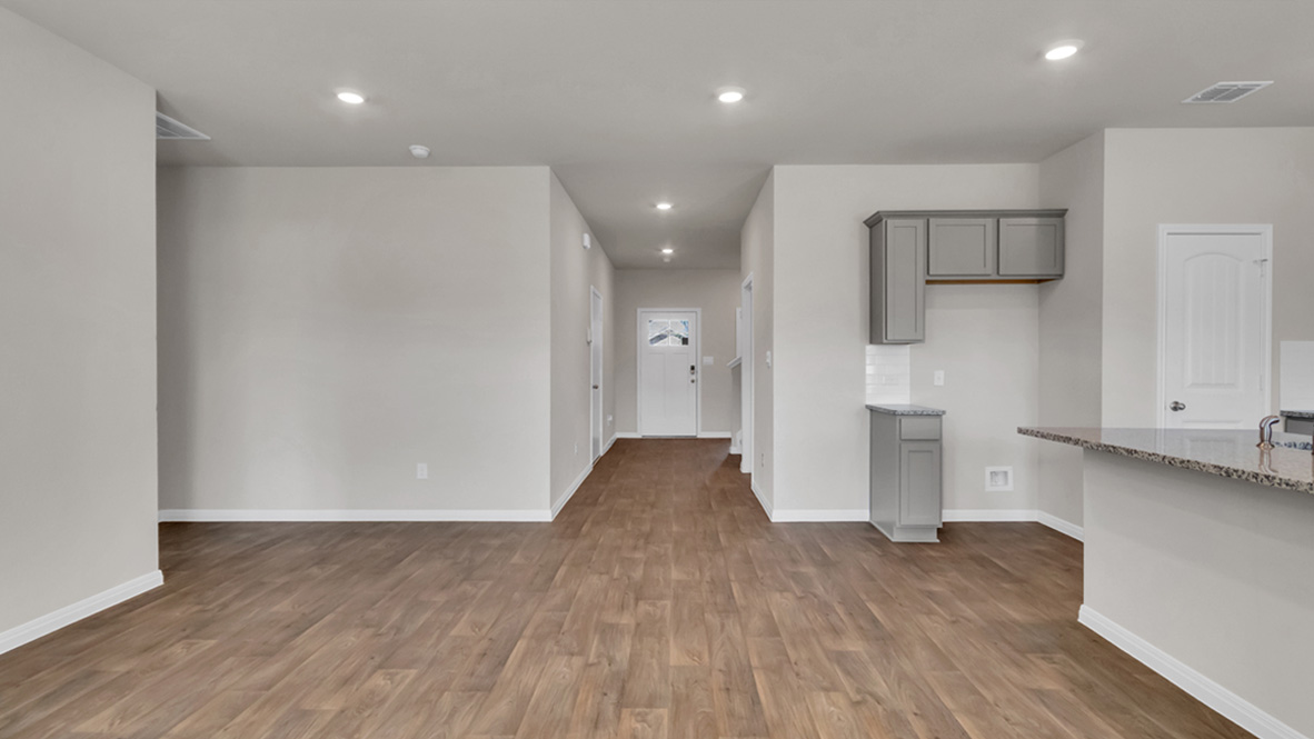 Entry hallway view to front door from living area shows open concept designs, flex and living spaces with upstairs, Carillon