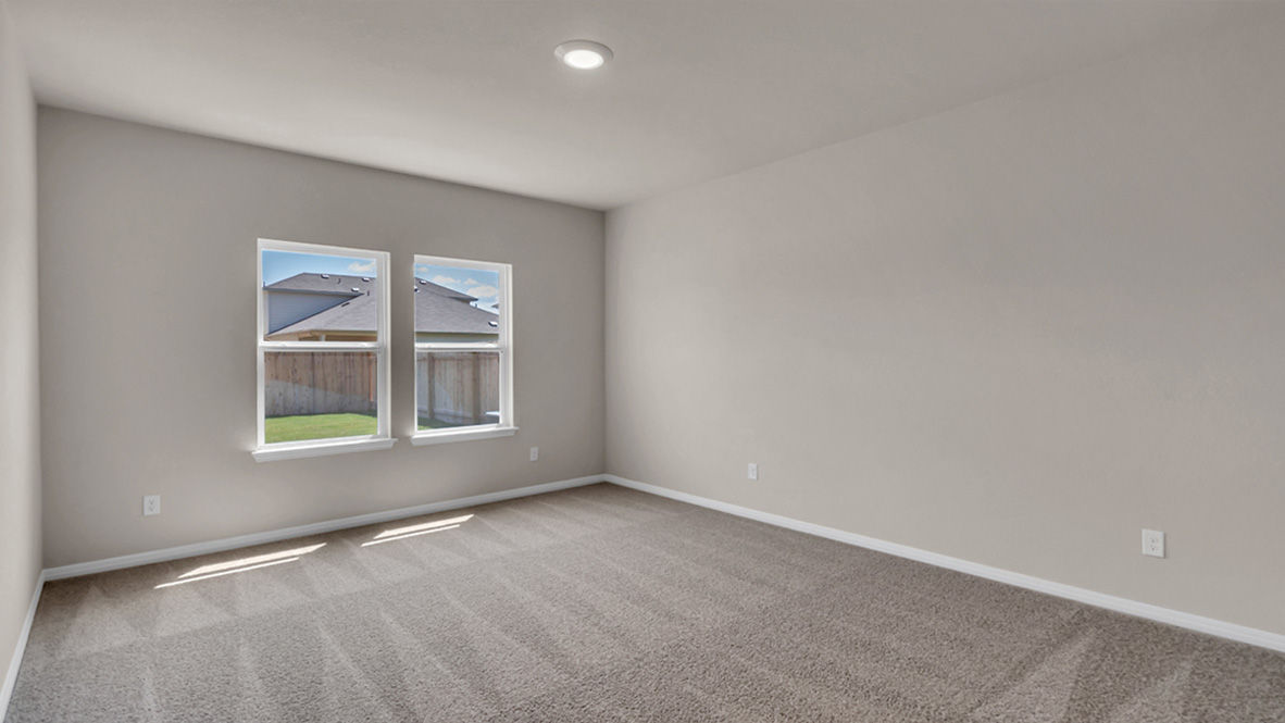 Owner’s suite on main level offers style and function with natural light, spa-inspired ensuite bathroom, walk-in closet