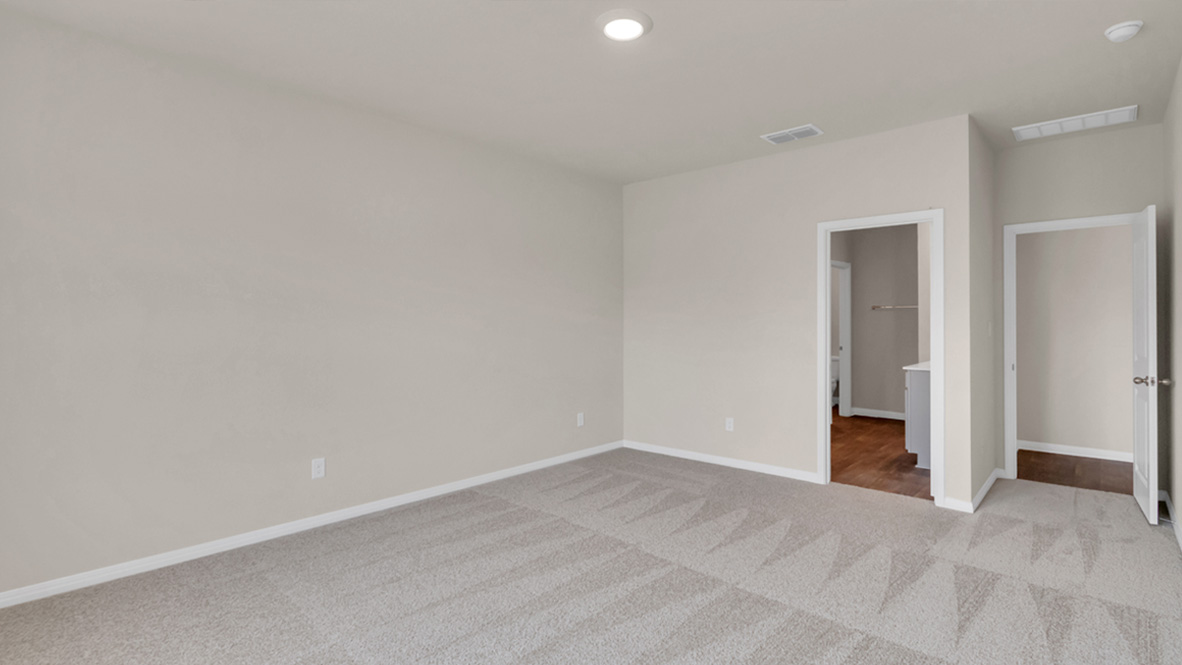Primary bedroom features ample space, double windows, soft carpet, a stylish walk-in closet, and a private ensuite bath