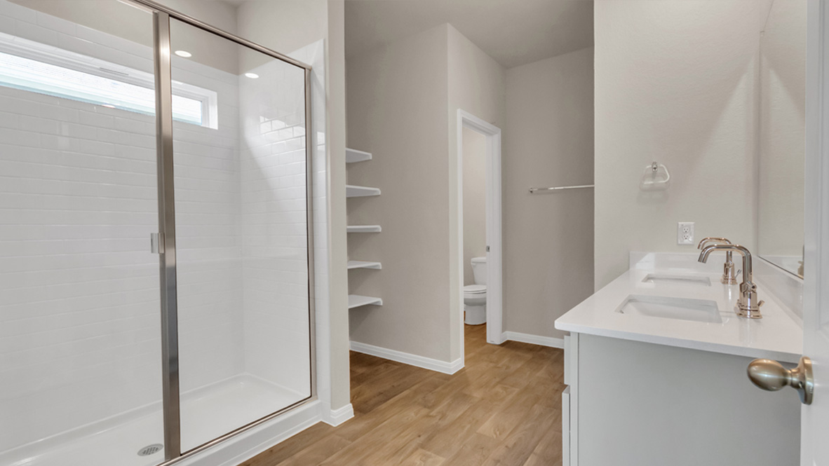 Owner’s ensuite in a new build home offers function and style with a walk-in closet, spa-like ensuite