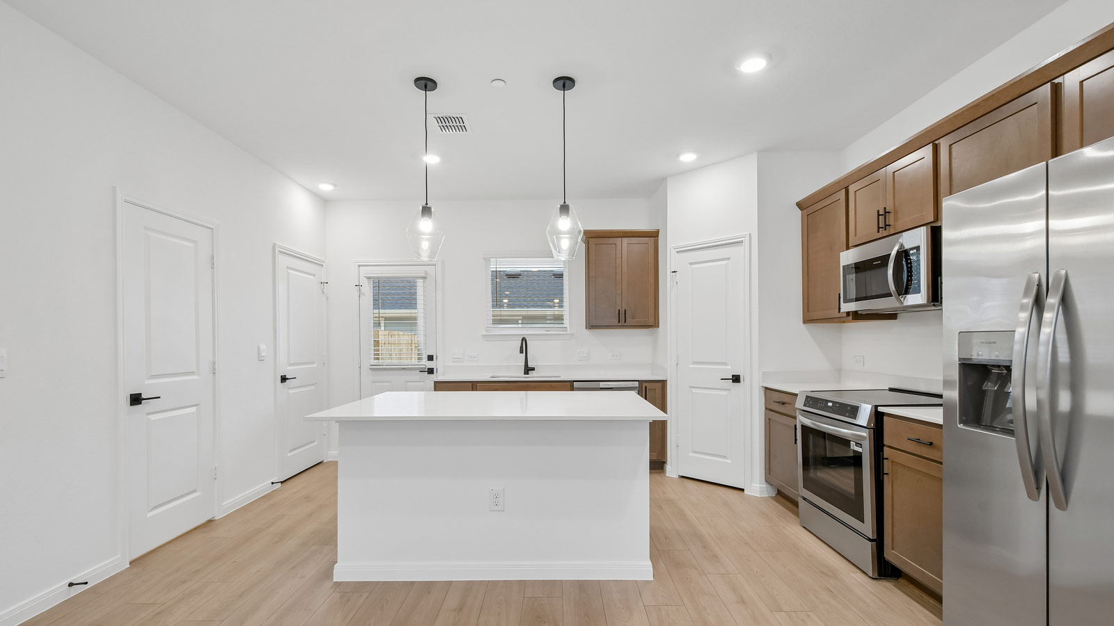 Stainless steel range, microwave, and dishwasher in kitchen.