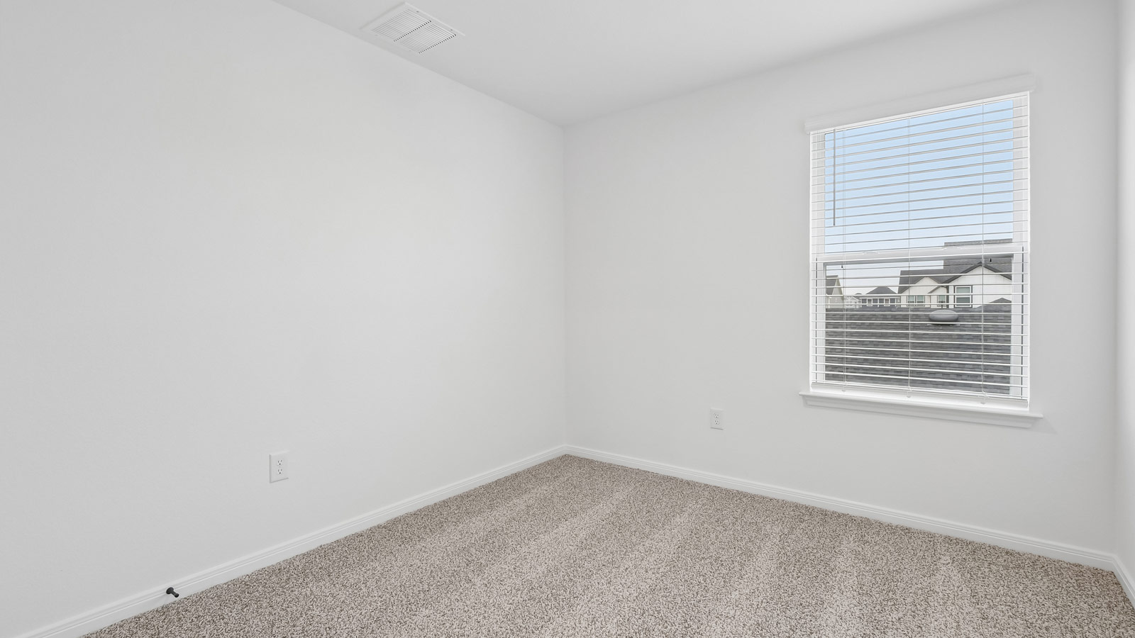 Bedroom 2 with carpeted flooring and window.