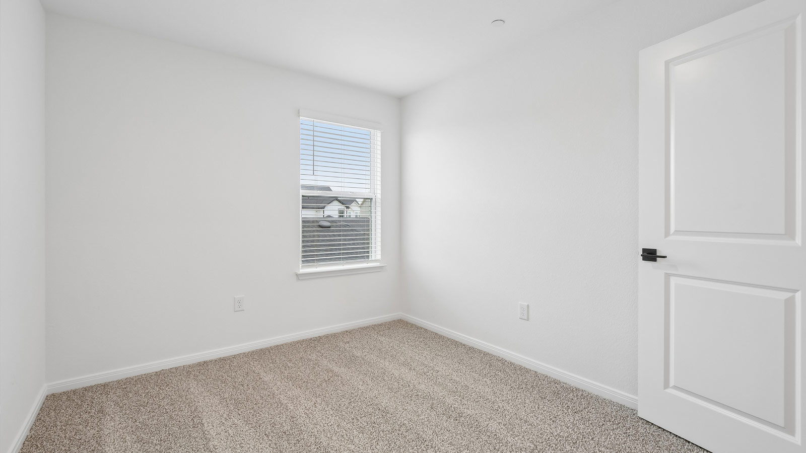 Bedroom 2 with carpeted flooring and window.