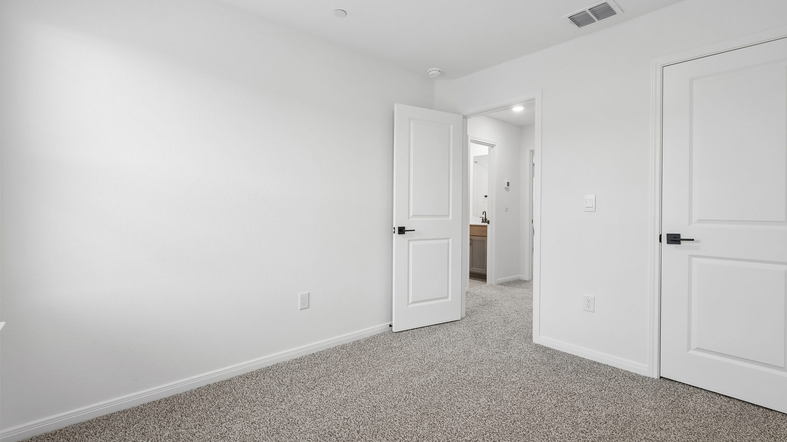 Bedroom 2 with closet and black hardware door handles.
