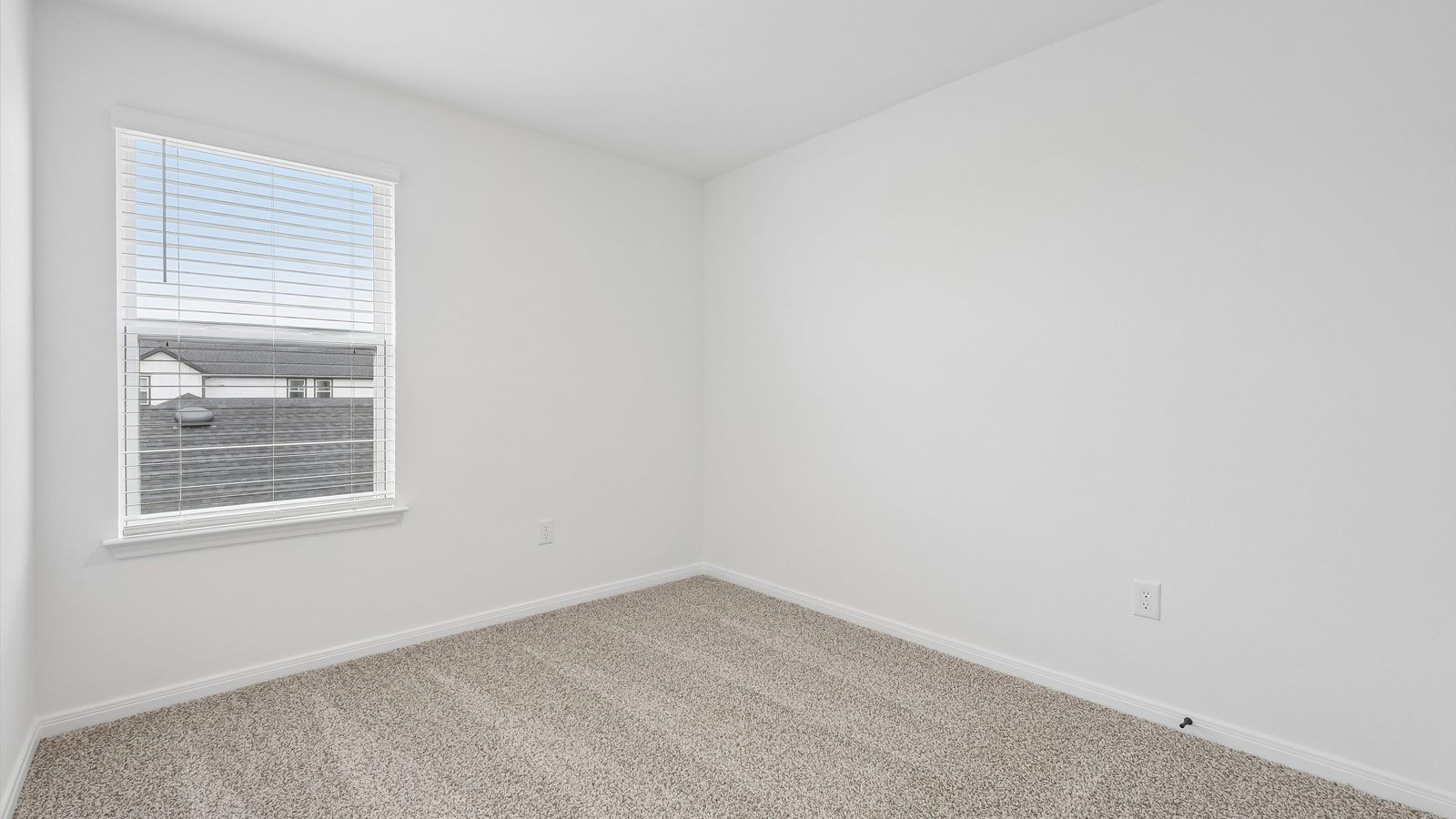 Bedroom 3 with carpeted flooring and window.