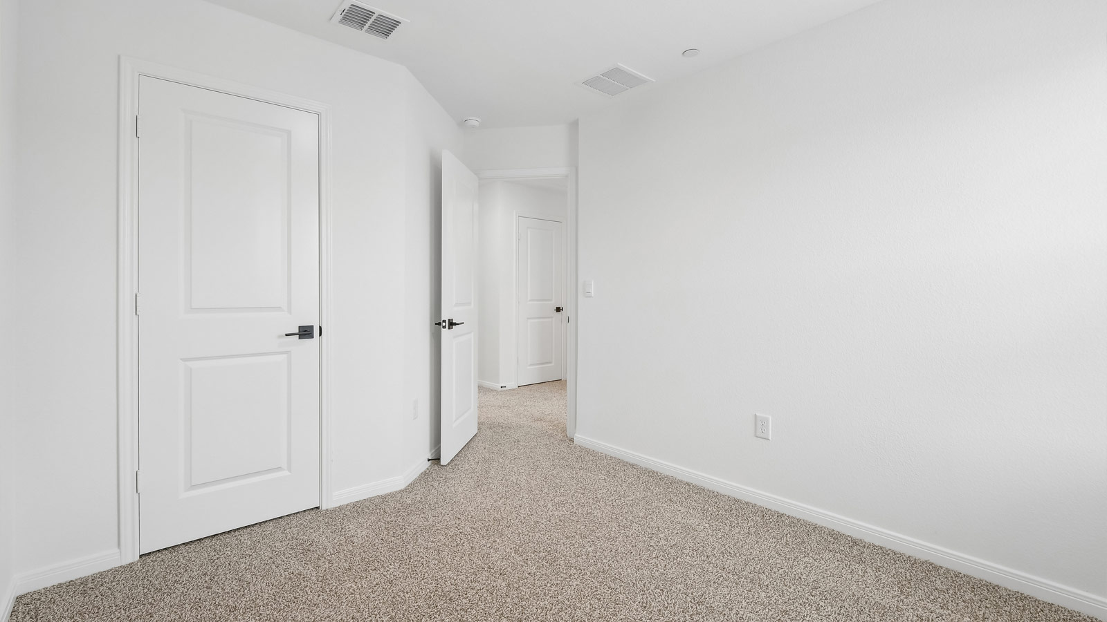 Bedroom 3 with carpeted flooring and window.