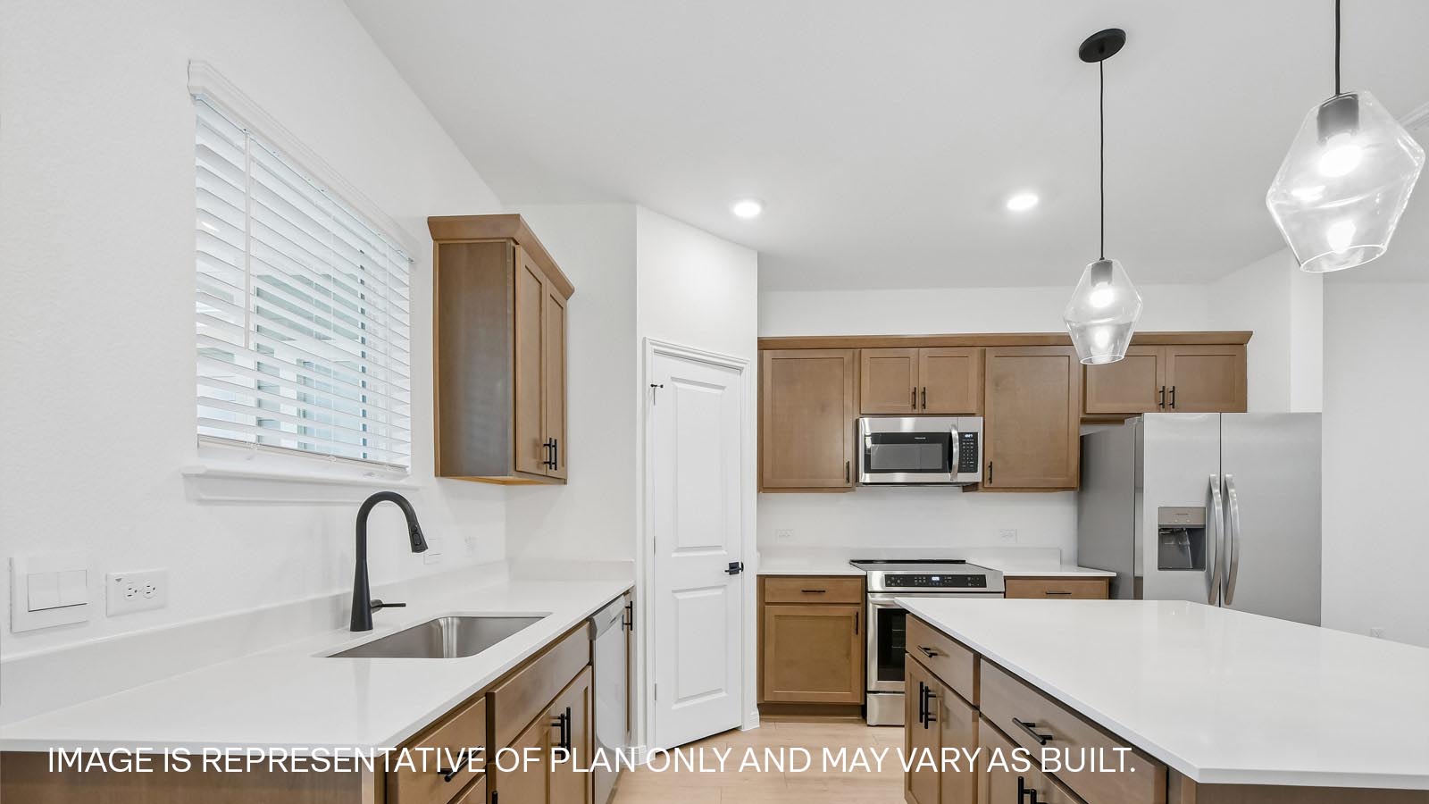 Beautiful kitchen with 2 pendant lights over kitchen island.