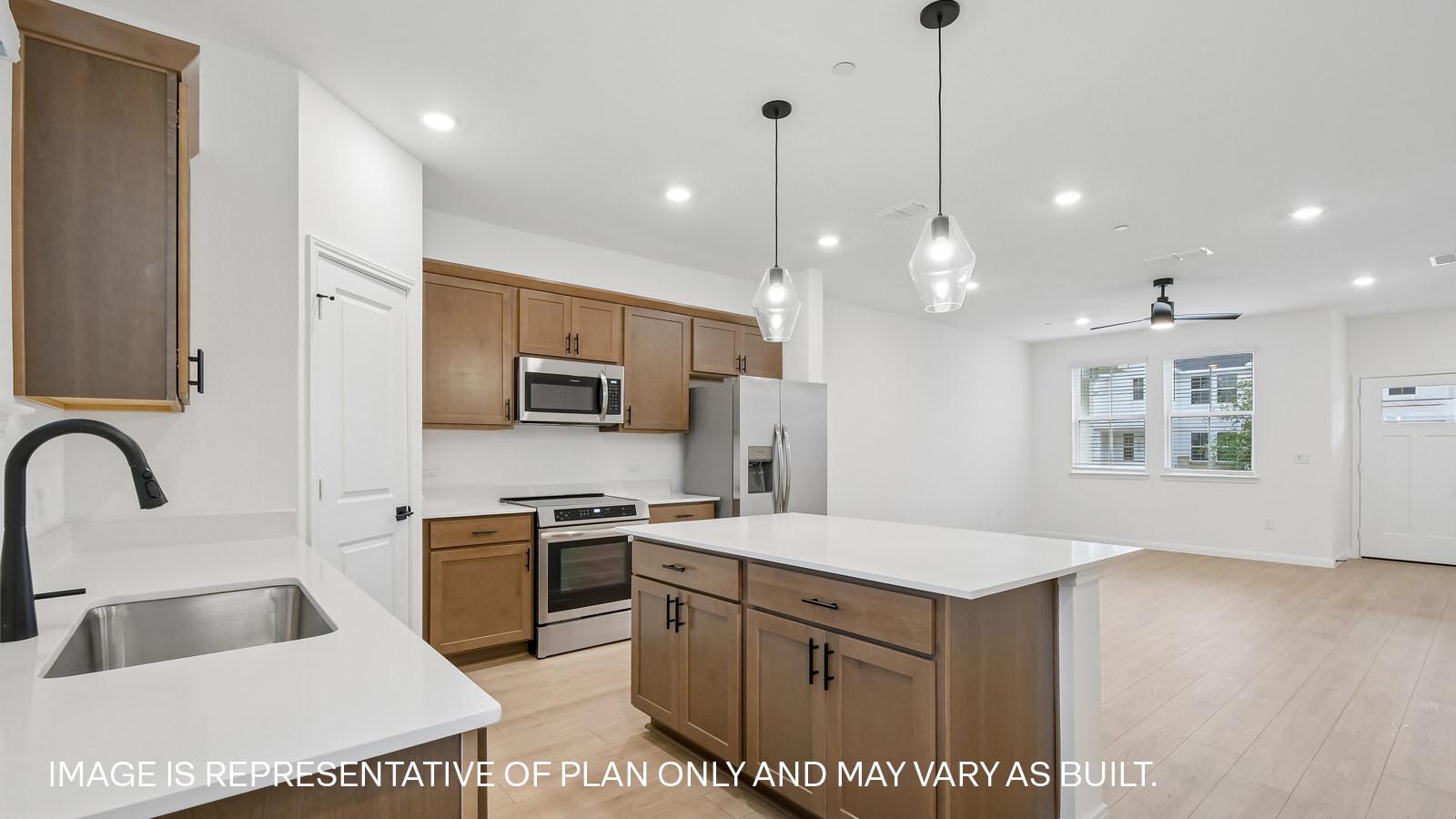 Kitchen with gooseneck faucet and single bowl undermount sink.