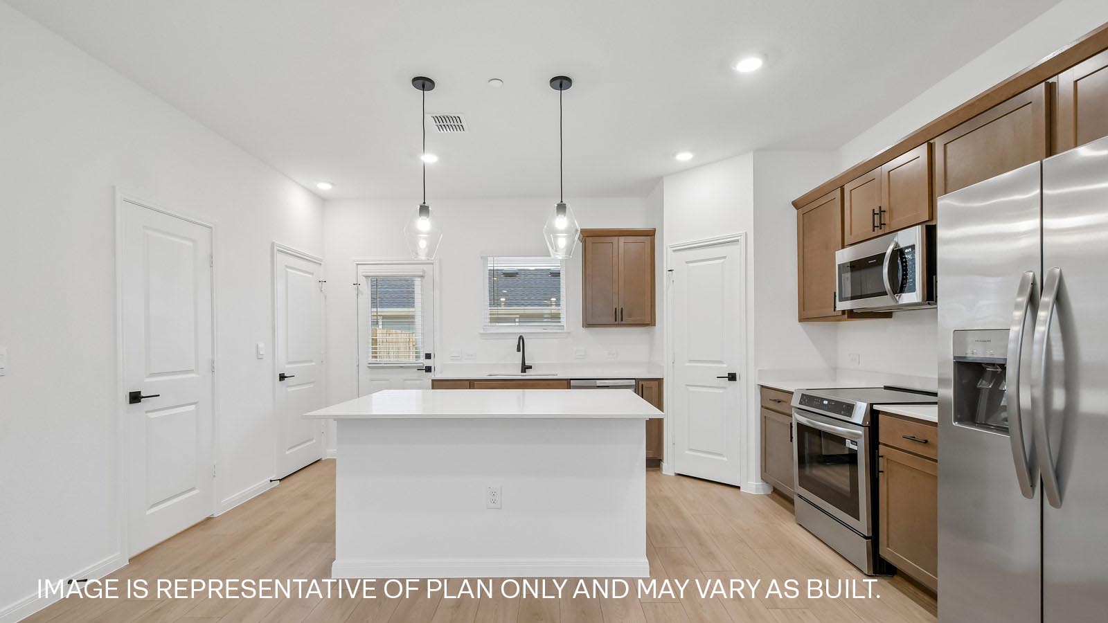 Stainless steel range, microwave, and dishwasher in kitchen.