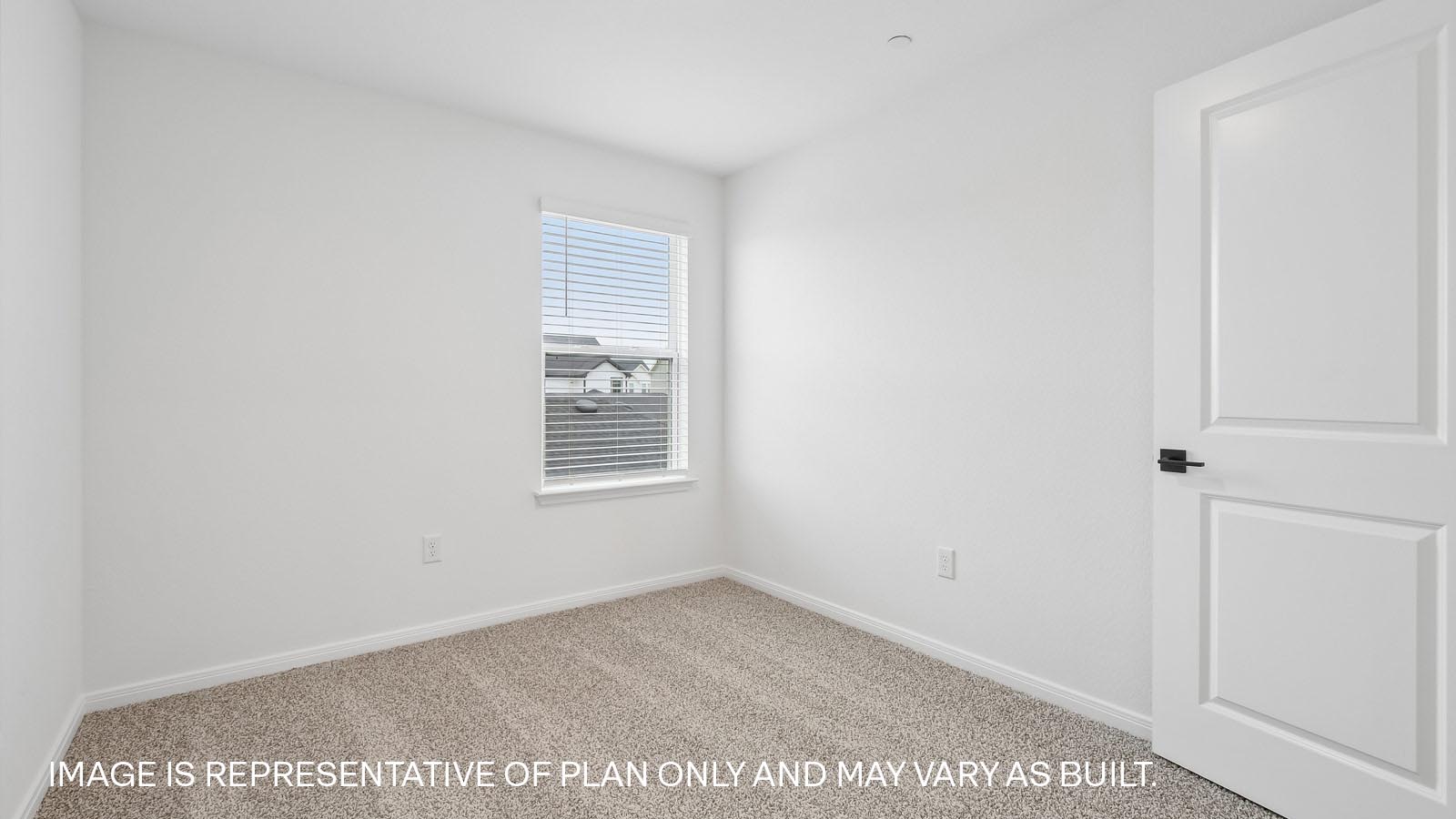 Bedroom 2 with carpeted flooring and window.