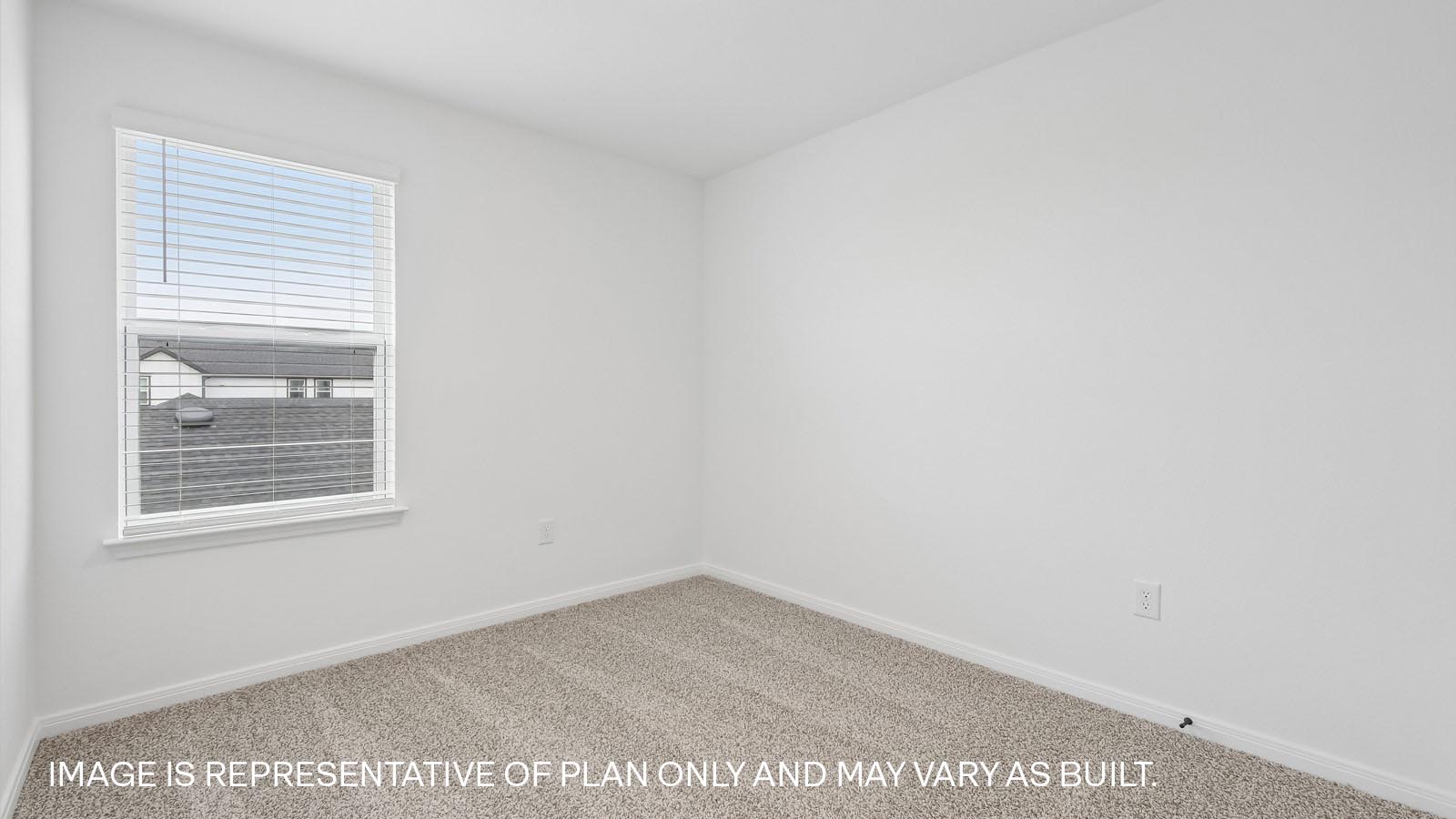 Bedroom 3 with carpeted flooring and window.
