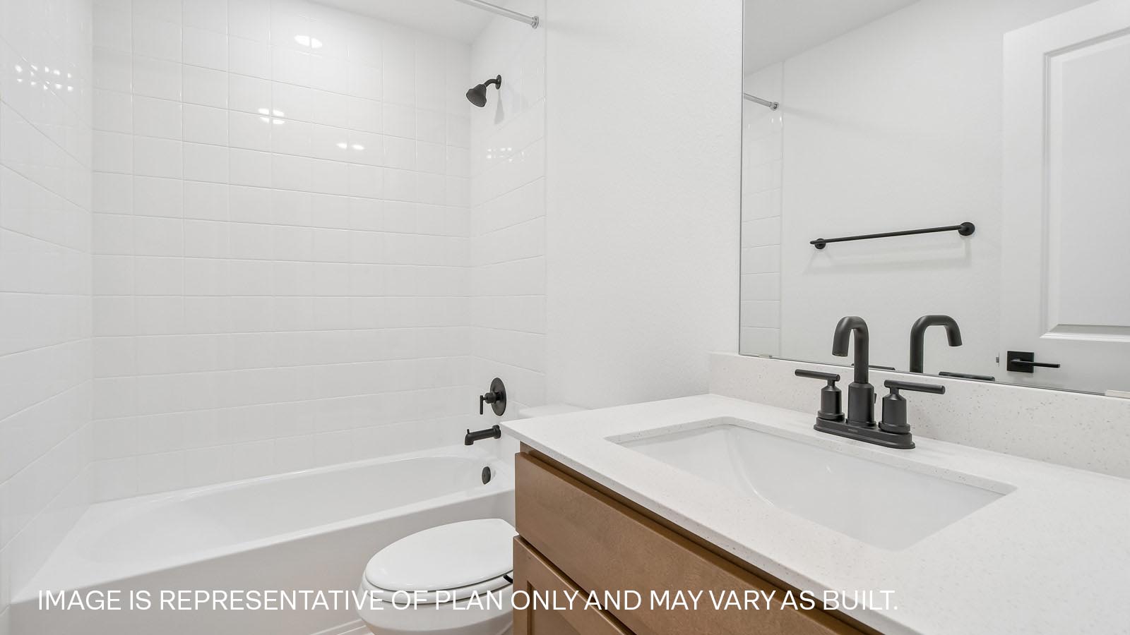 Secondary bathroom with quartz vanity sink, bathtub, and raised shower head.