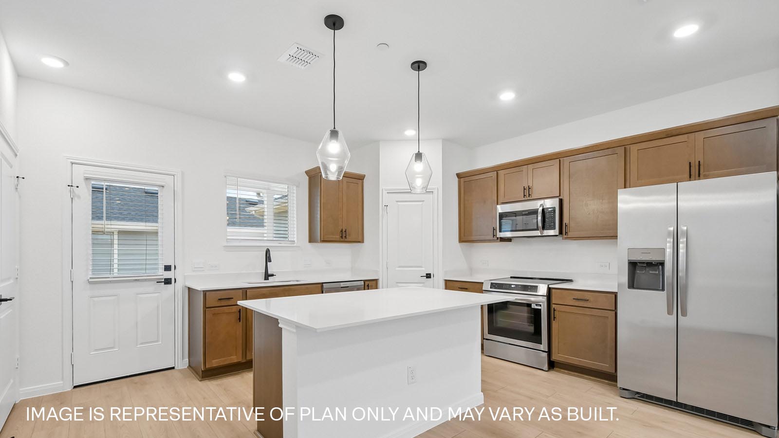 Kitchen with picture frame cabinets, quartz countertops, and black hardware.