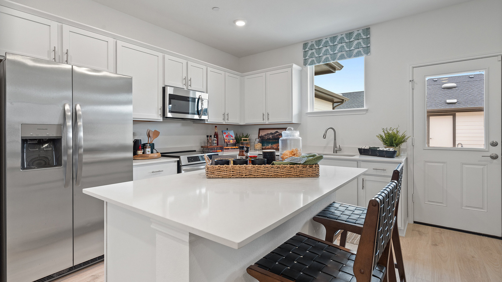 Central kitchen island anchors the home adding a dining option, full sink, pantry and storage, multi-prep zones