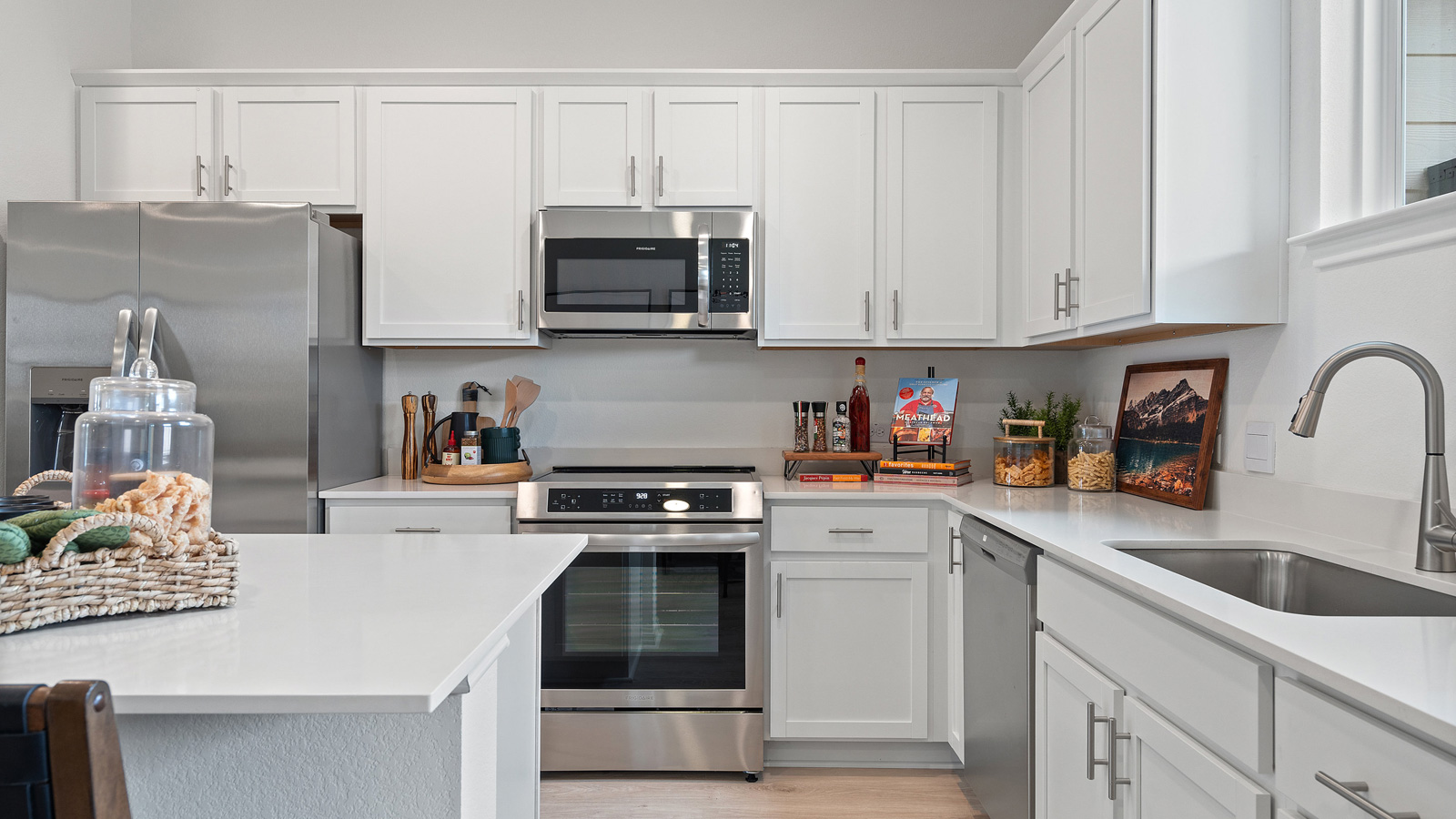View from dining room into kitchen with island, pantry, new appliances and cabinet options Avery Centre By D.R. Horton