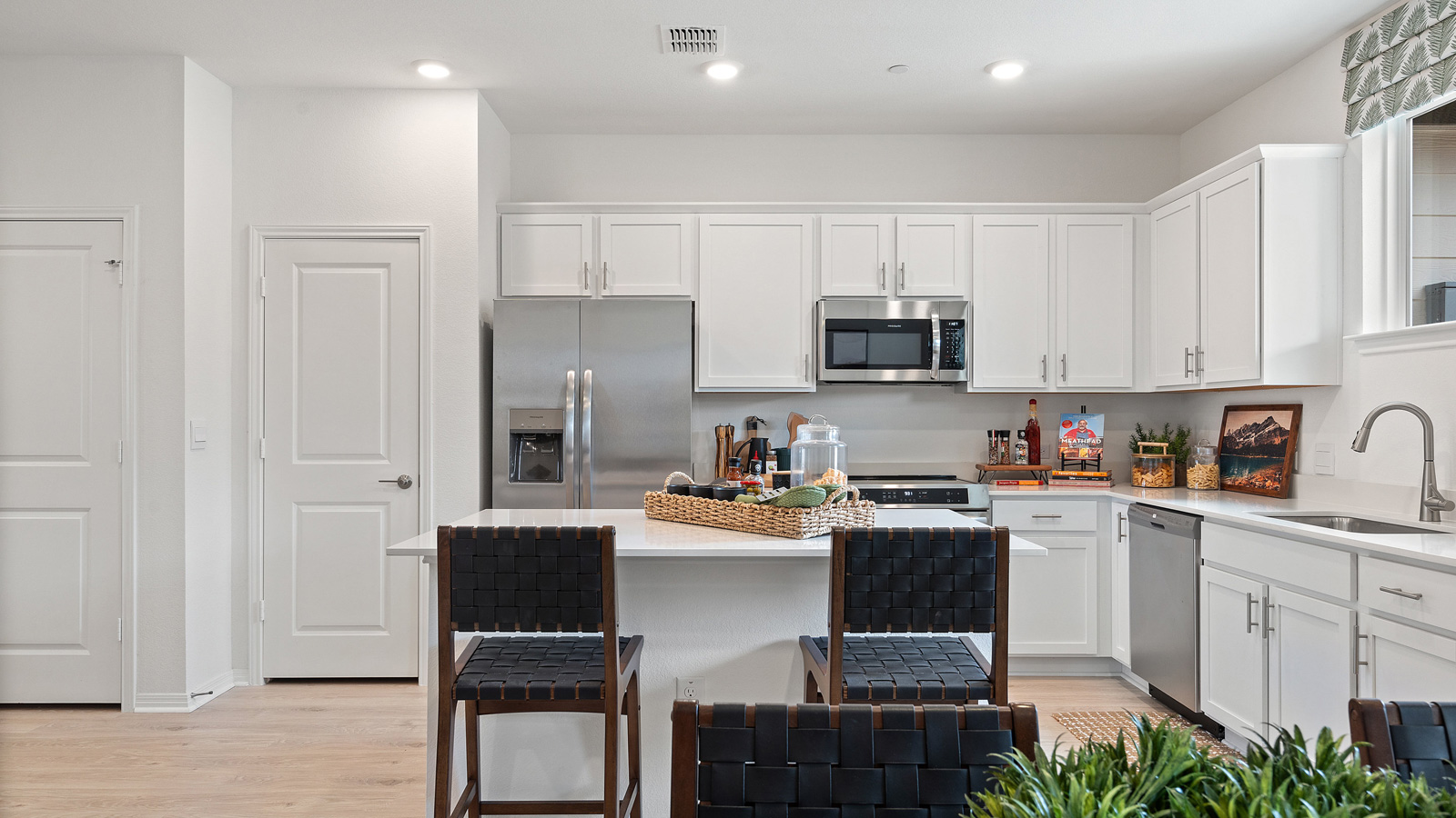 Central kitchen island anchors the home adding a dining option, full sink, pantry and storage, multi-prep zones Avery Centre By D.R. Horton