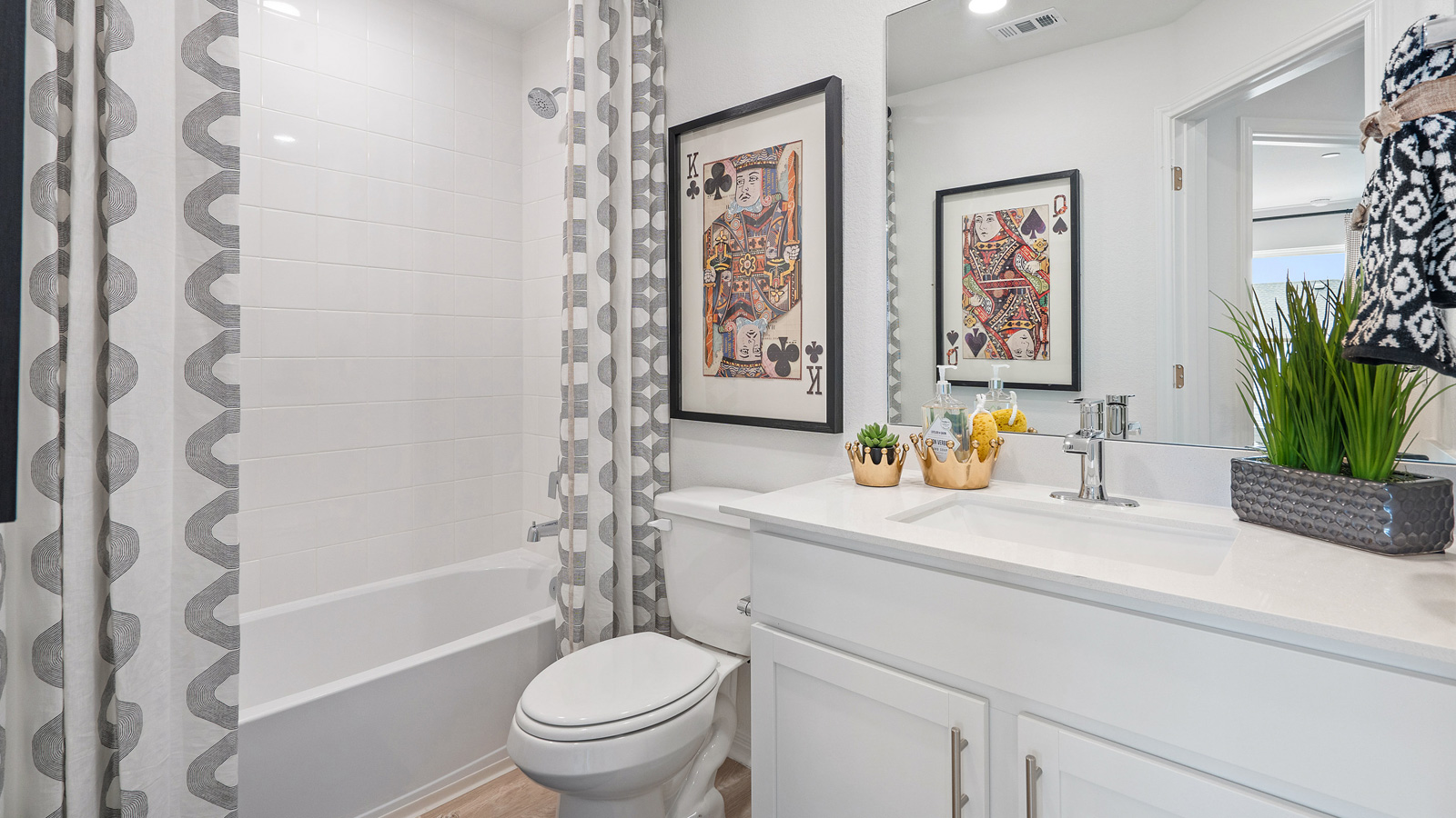 Family full bathroom 2 with stylish vanity, mirror, polished fixtures, cabinets, tub-shower combo