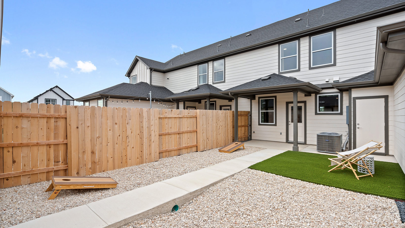 Covered rear patio in this D.R. Horton new home with outdoor living and private backyard views from the open concept layout