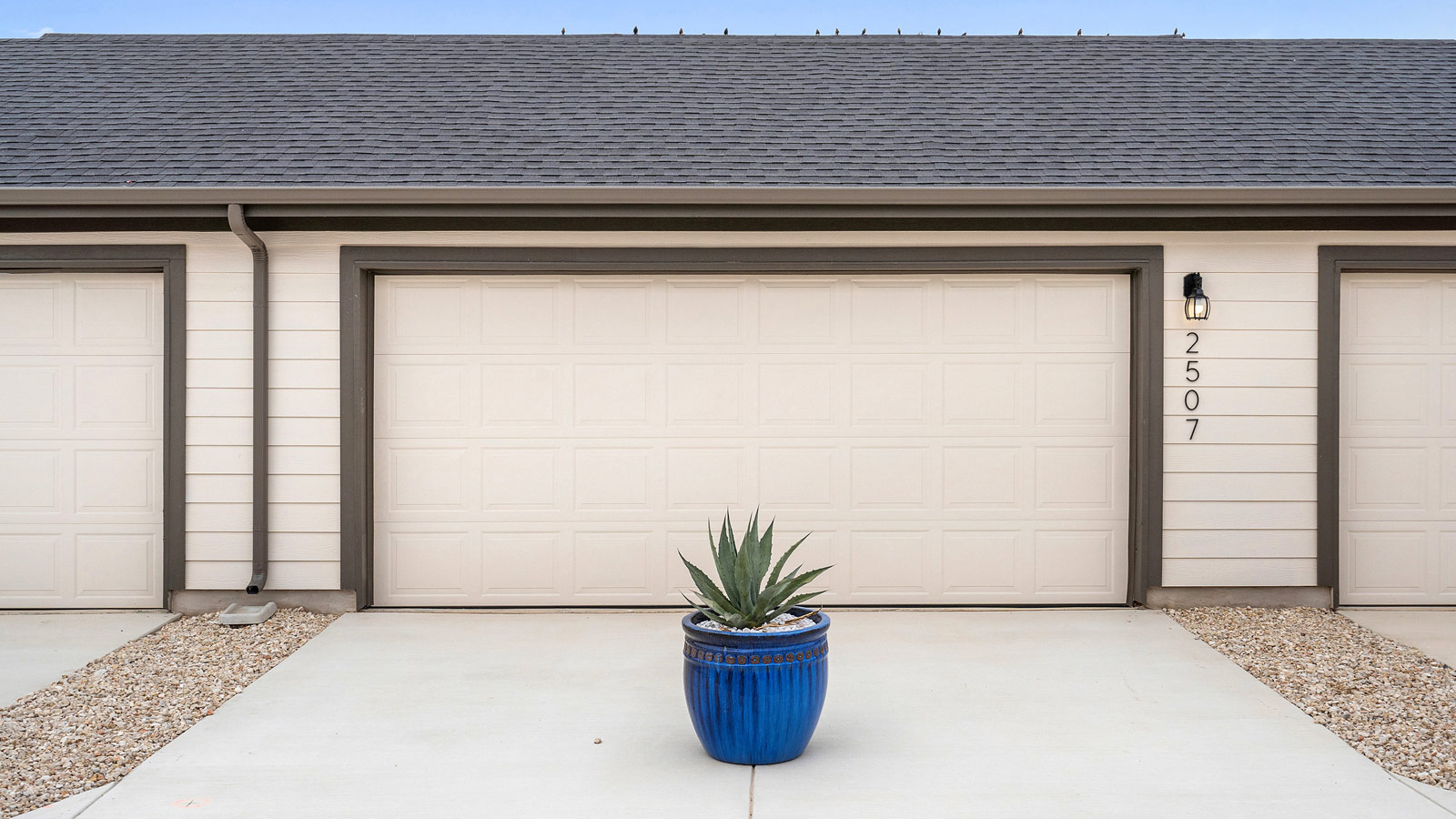 Curbside view of 2-car garage Avery Centre By D.R. Horton