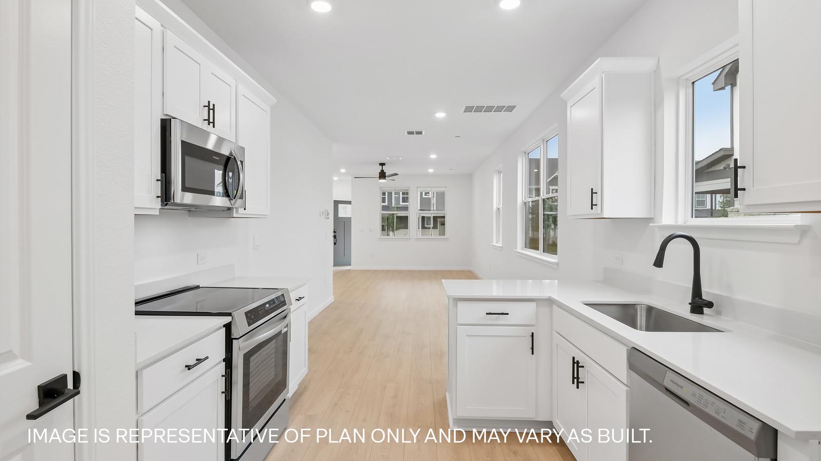Beautiful kitchen with cabinets and quartz countertops.