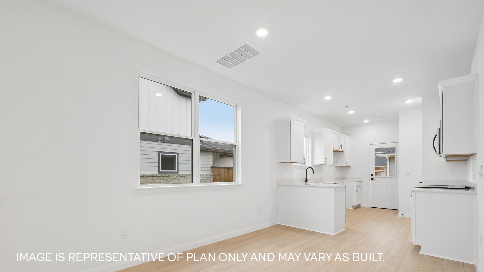 Beautiful kitchen with cabinets and quartz countertops.