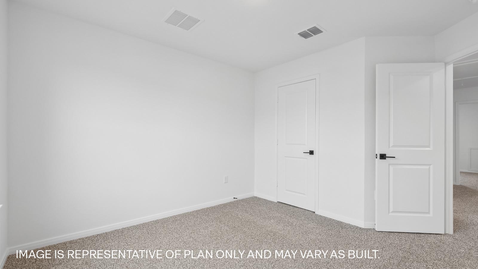 Bedroom 2 with carpeted flooring.