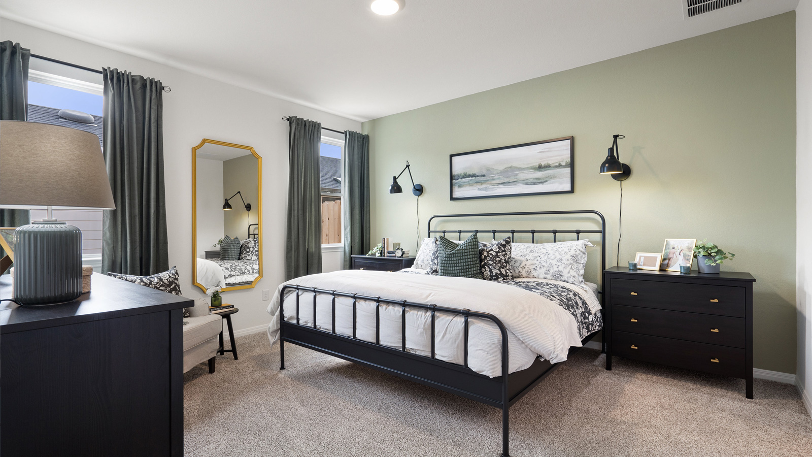 Primary bedroom with two windows.