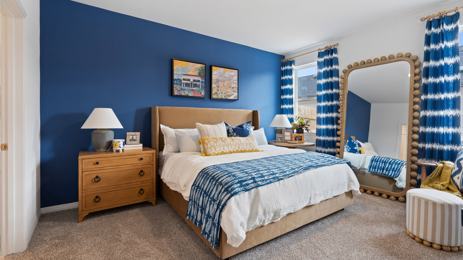The main bedroom, bedroom 1, with window and carpeted floors.