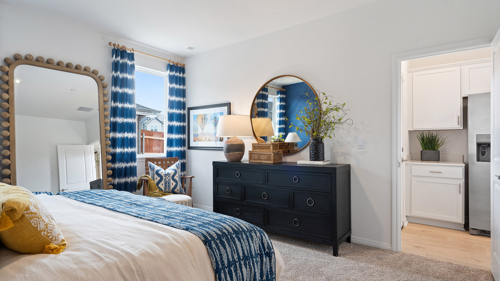 The main bedroom, bedroom 1, with window and carpeted floors.