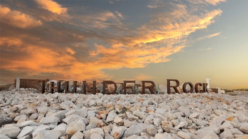 Thunder Rock monument with name of community.