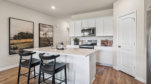 Kitchen featuring cabinets, new stainless steel appliances, and a large standing island.