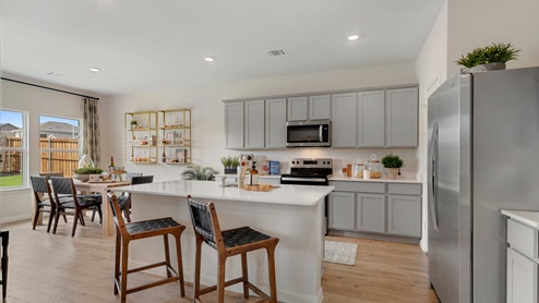 Kitchen featuring brand new stainless steel appliances, cabinets, and a large island.