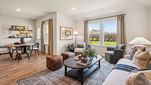 Bright living room with large windows and neutral walls.