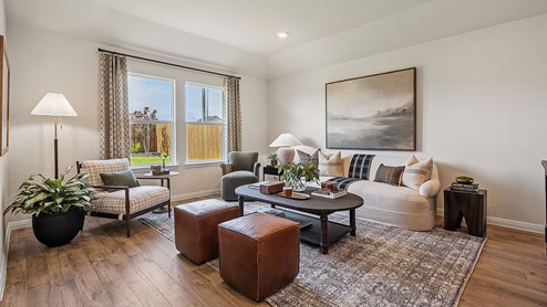 Living area with simple furnishings and an area rug.