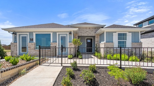One story home with large windows and a gate.