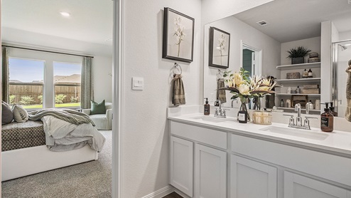 Bathroom with dual sinks and a wide mirror.