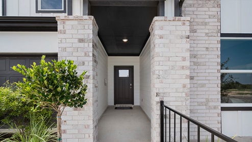 Front door to home with stone detailing leading to doorway.