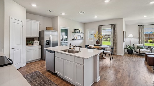 Kitchen featuring cabinets, new stainless steel appliances, and large countertops connecting to dining area.