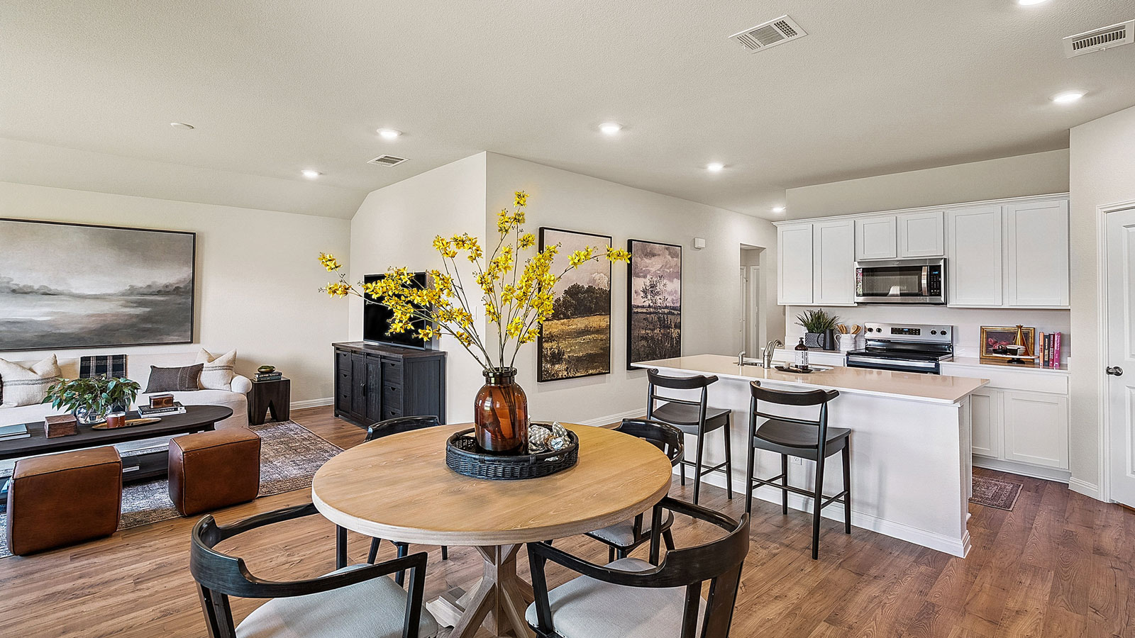 Open concept dining area with simple furnishings off the living room and kitchen.